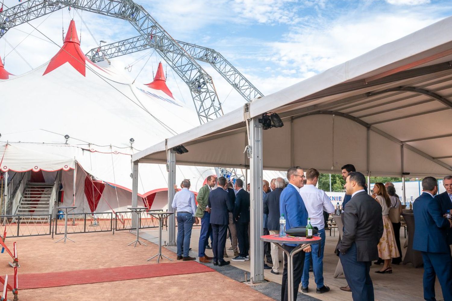 Commodity trading executives at an evening anniversary gathering under a circus big top in Geneva.
